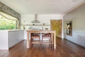 a kitchen with a wooden table and chairs in a room at Casa Ishi - at lumicollection in Miami +18 photos