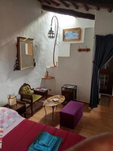 a living room with a bed and a table at la casina di asia in Semproniano