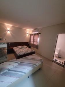 a bedroom with two beds in a room at hotel royal brás in Sao Paulo