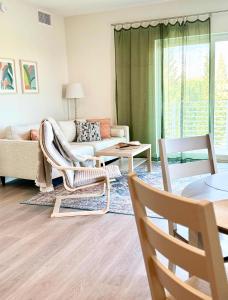 a living room with a couch and a table at NEW Modern Condo FREE Parking & High Speed Wifi in Hollywood