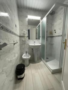 a bathroom with a sink and a shower and a toilet at Hotel Roca Bella in Es Pujols