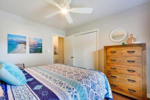 a bedroom with a bed and a dresser and a ceiling fan at Ideally Located High Point Condo with Patio! in High Point