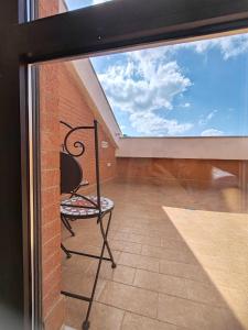 a glass door with a chair sitting on a balcony at B&B Colli Ameni in Candela +45 photos