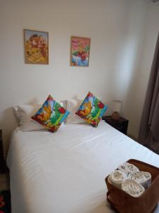 a white bed with two pillows and a tray of towels at B306 Appartement DisneyLand Paris in Montévrain