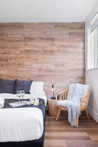 a bedroom with two beds and a table and a chair at Cozy 1 bedroom apartment - Caulfield park in Melbourne