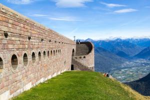 a wall on a hill with a view of mountains at Casa Palma - Happy Rentals in Lugano