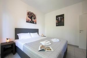 a bedroom with a bed with a magazine on it at Casa Palma - Happy Rentals in Lugano