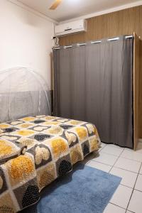 1 dormitorio con 1 cama con cortina de ducha en Tout confort à proximité de tout, en Case-Pilote