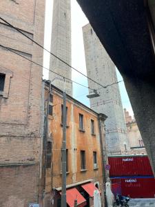 an old building with two towers on a city street at Maison under the towers in Bologna