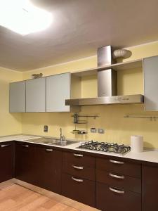a kitchen with a sink and a stove top oven at Maison under the towers in Bologna +10 photos