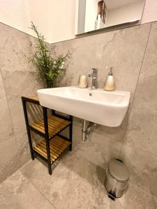 a white sink in a bathroom with a mirror at NEU Große Einzimmerwohnung im Zentrum Goldstadt Pforzheim Schlössle in Pforzheim