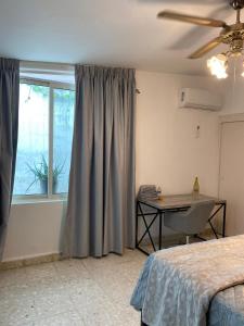 a bedroom with a bed and a table and a window at Luna Menguante in Monterrey +45 photos