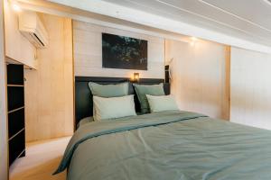 a bedroom with a large bed in a room at Le Cabanon Grand-Heid 2-4p in Lierneux +48 photos