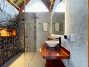 a bathroom with a sink and a glass shower at Zirwa Hotel Boutique - Dentro del Parque Tayrona in El Zaino +46 photos
