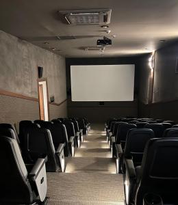 a cinema room with chairs and a white screen at Grand Tower Del Valle in Mexico City +20 photos