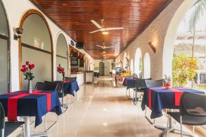 a dining room with tables and chairs in a building at Best Western Jangwani Sea Breeze Resort in Dar es Salaam