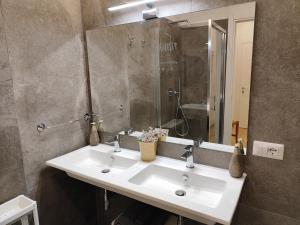 a bathroom with a white sink and a mirror at A&B Vatican Domus in Rome +19 photos