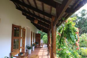 an outdoor porch with a wooden pergola at La Mer Resort, Phú Quốc in Phú Quốc
