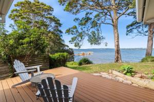 a deck with chairs and a view of the water at Long Beach Hideaway in Long Beach