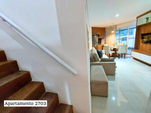 a living room and kitchen with a staircase in a house at Book Santos - Estanconfor Cobertura com Jacuzzi e Vista Mar in Santos