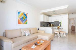 a living room with a couch and a table at Apartment in Palm Mar - Insel Teneriffa 53099 in Palm-mar