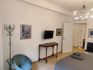 a living room with a blue chair and a table at A&B Vatican Domus in Rome