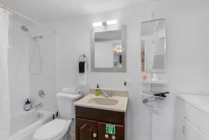 a white bathroom with a toilet and a sink at Green Lake Zen Garden Basement in Seattle +19 photos