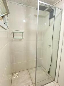 a shower with a glass door in a bathroom at GREEN HOUSE - com linda vista para o mar in Palhoça