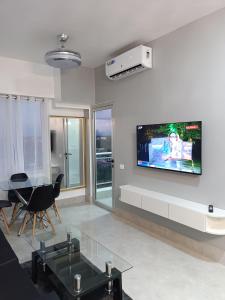 a living room with a flat screen tv on the wall at Boca del Mar III, apto 707 in Boca Chica