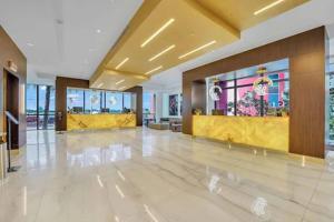 a large lobby with a yellow counter in a building at Hollywood Studios Condo Costa in Hollywood +20 photos