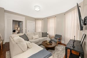 a living room with a couch and a table at 3 Bed Spacious 1st Floor Apt at Tremont in Cleveland