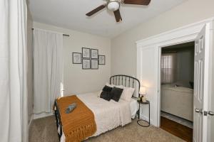 a bedroom with a bed and a ceiling fan at 3 Bed Spacious 1st Floor Apt at Tremont in Cleveland