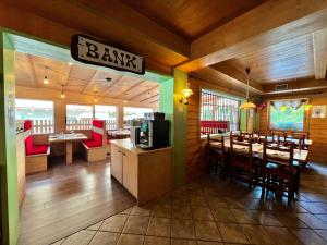 a restaurant with a bar with tables and chairs at La Locanda in Livigno