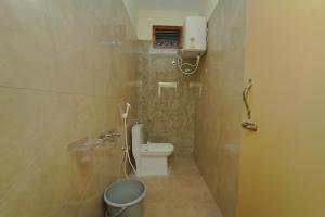 a bathroom with a toilet and a sink at Pinaka Grand Home Stay in Tirupati