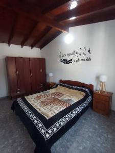 a bedroom with a bed and a wall with writing on it at Casitas sc in San Clemente del Tuyú