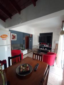 a kitchen with a table with a plate of fruit on it at Casitas sc in San Clemente del Tuyú