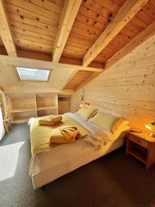 a bedroom with a large bed in a wooden ceiling at La Locanda in Livigno