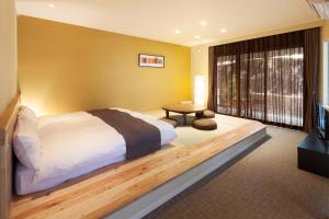 Postel nebo postele na pokoji v ubytování Karuizawa Hotel Longing House
