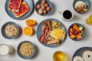 a table with plates of breakfast foods and coffee at Hyatt Place Secaucus Meadowlands in Secaucus