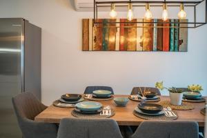 a dining room table with chairs and a dining room at Seaside luxury villa with a swimming pool Razanj, Rogoznica - 23572 in Rogoznica