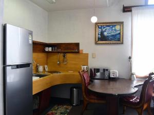 a kitchen with a table and a refrigerator at Yangyang Darosan Pension in Yangyang