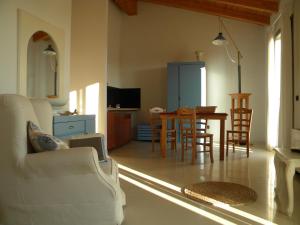a living room with a table and chairs at La Foresteria di Borgogelsi Apartments in Sanguinetto