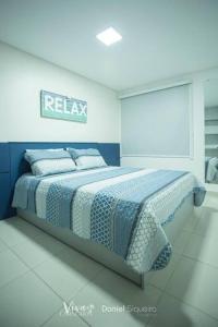 a bedroom with a bed with a sign on the wall at Flat Praia dos Carneiros in Tamandaré
