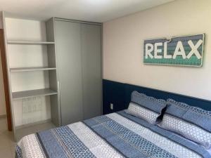 a bedroom with a bed and a sign on the wall at Flat Praia dos Carneiros in Tamandaré