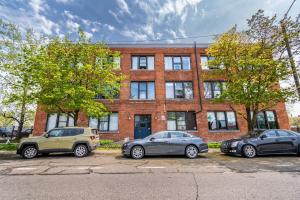 three cars parked in front of a brick building at 420 Friendly Canada Bridge View Loft Downtown FREE parking in Detroit