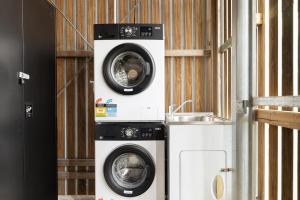 two washing machines sitting next to each other at Smart Suites Self Check-in Apartments - Rocklea Station S in Brisbane