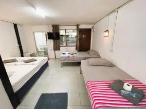 Postel nebo postele na pokoji v ubytování Tuk Tuk Guesthouse