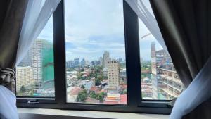 a view of a city from a window at Anika's Staycation at BE Residence Lahug in Cebu City