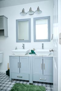 a bathroom with two sinks and two mirrors at Home away from Home in Waldorf