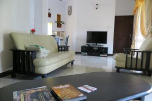 a living room with a couch and a table at Villa16Hikkaduwa in Hikkaduwa